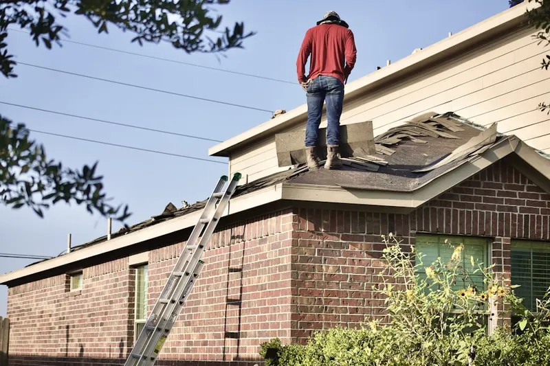 Professional roofer working on a residential roof in Garden Acres